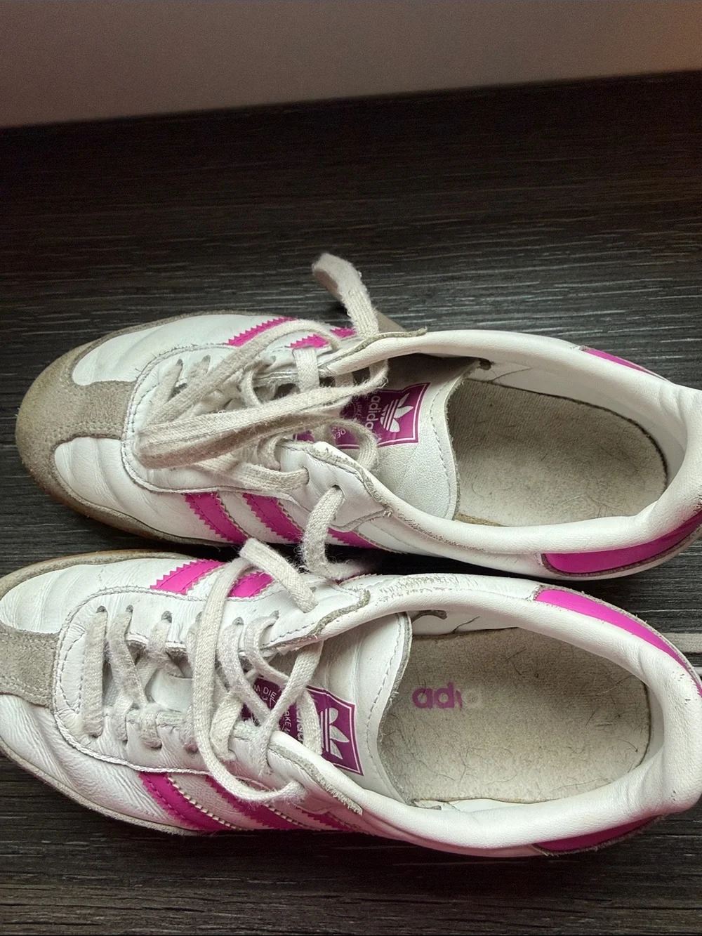 Adidas Samba sneakers in white with bright pink stripes and classic gum sole.